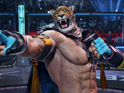 Tekken 8 - King, a man in a tiger mask, holds a microphone and points.